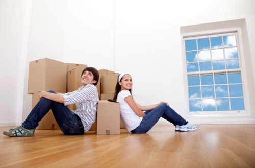 Packed moving boxes and furniture ready for transport in Edgware