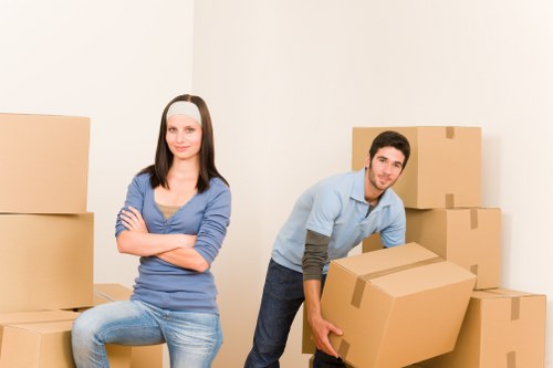 Professional movers handling boxes and furniture in a local property